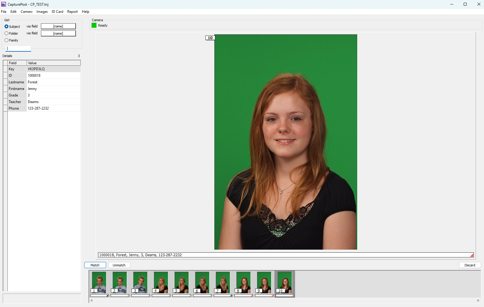 A young girl with red hair smiles for a school photo against a green background.