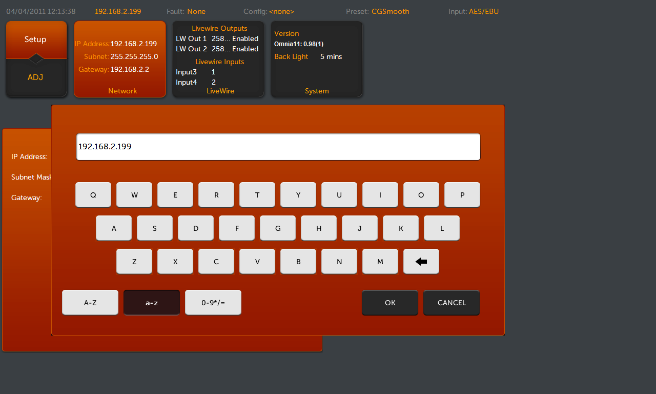 Screenshot of a device network settings UI showing a dark grey background and an orange settings panel with a white IP address input field set to 192.168.2.199 and an on-screen orange keyboard below it with keys and OK/CANCEL buttons