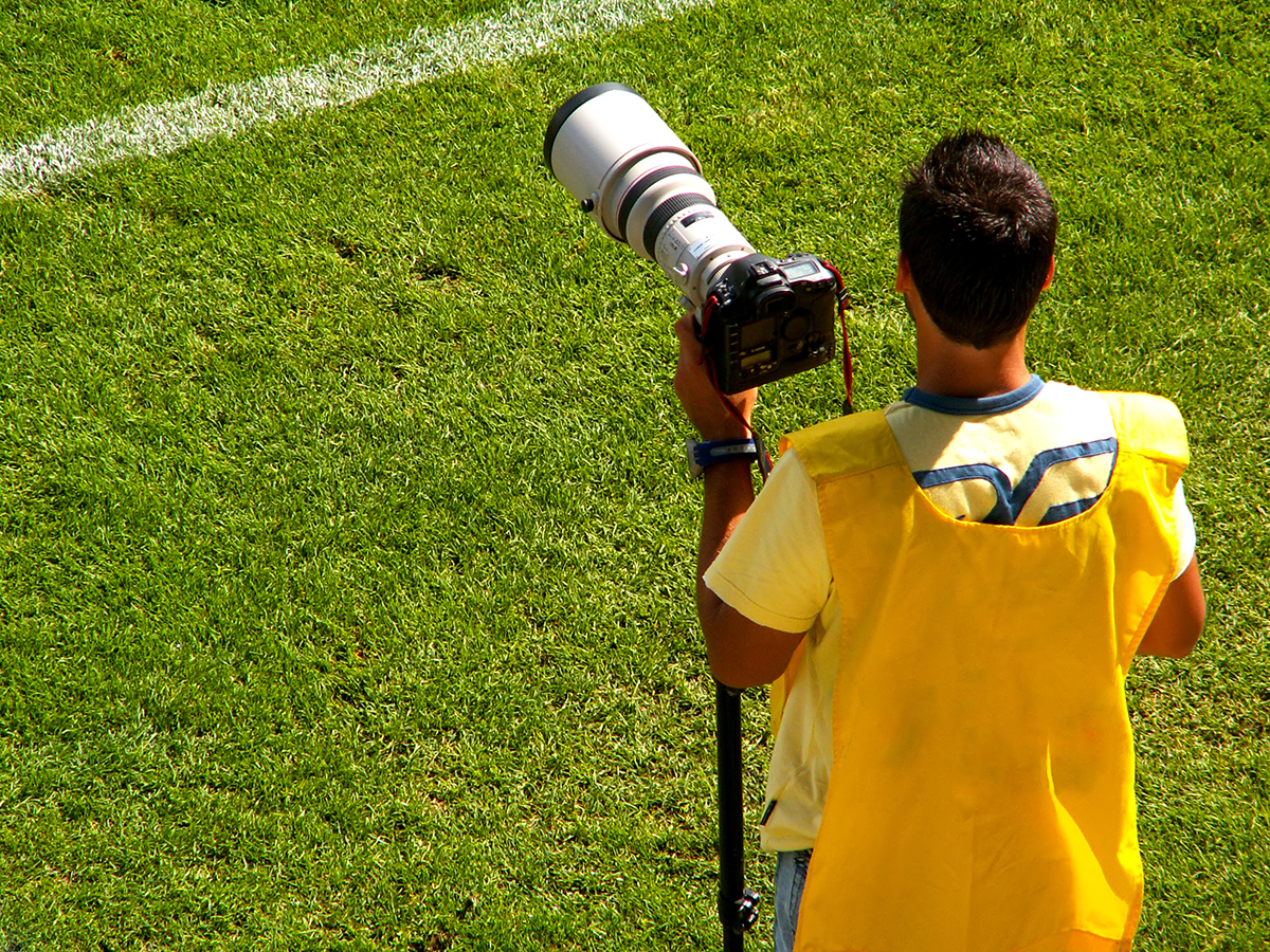 Photographer standing on sports field