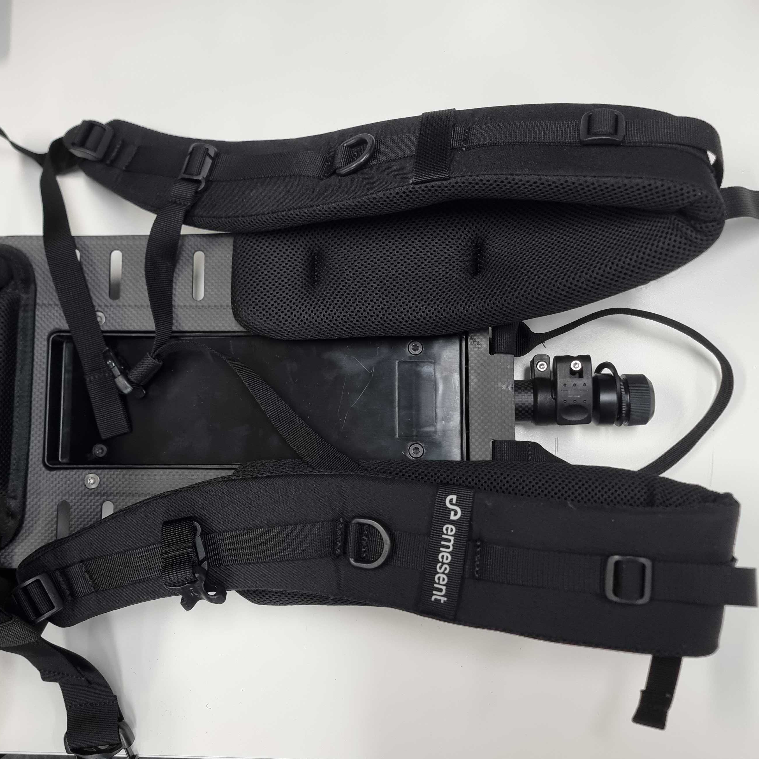 The GX1 Backpack Harness flat on a table. The shoulder pads and straps face up.