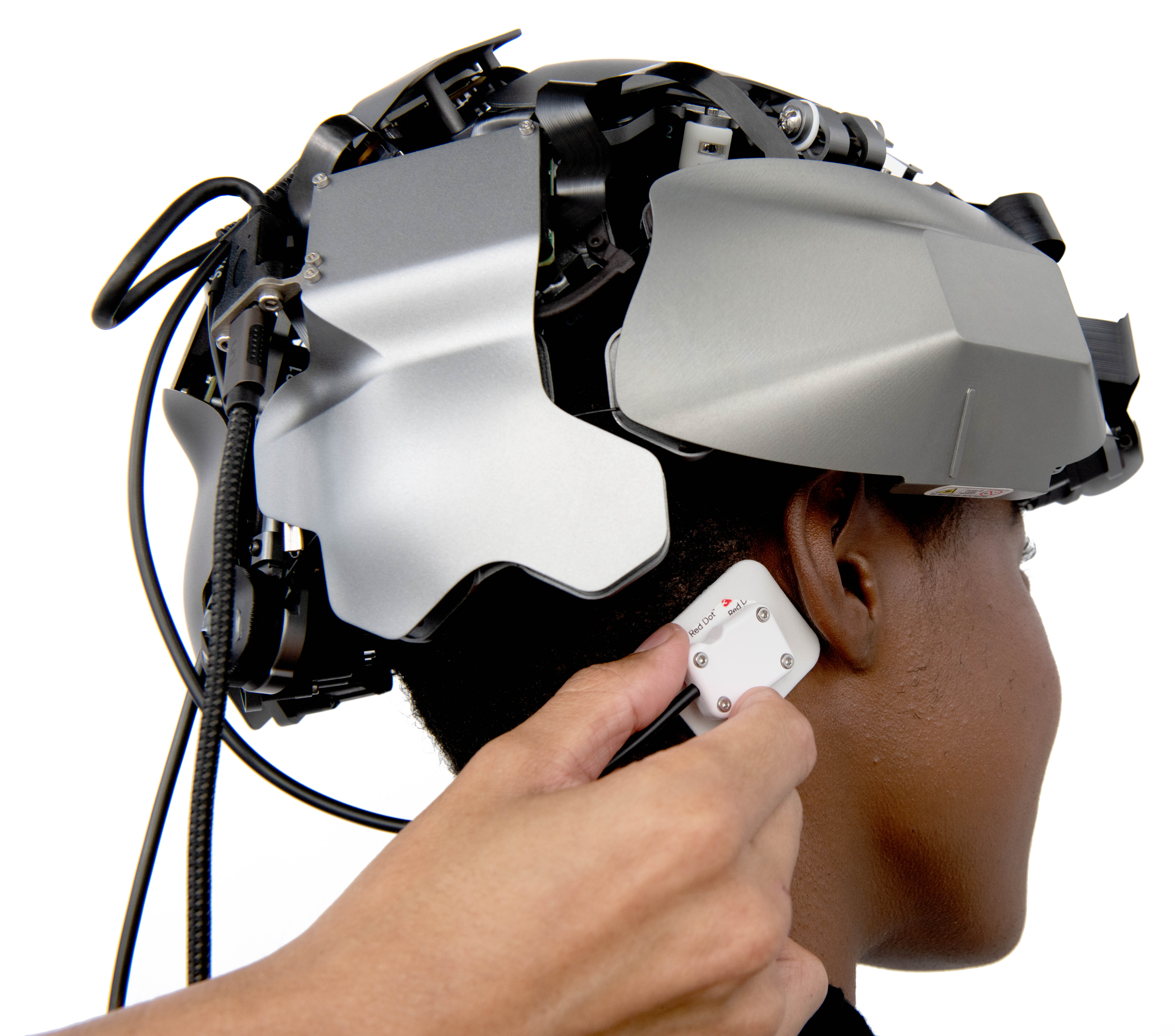 Image Kernel Flow headset on a participant, researcher affixing electrode behind participant's ear.