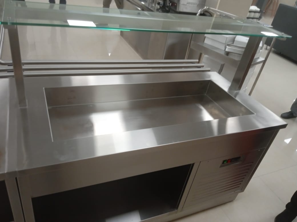A stainless steel sink with a glass top Description automatically generated
