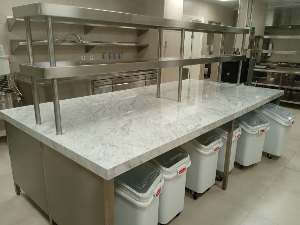 A kitchen counter with metal railings Description automatically generated