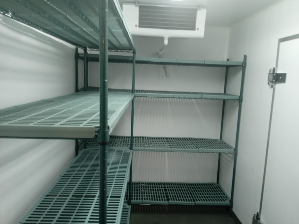 A room with shelves and a vent Description automatically generated