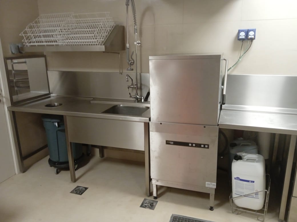 A stainless steel sink in a kitchen Description automatically generated