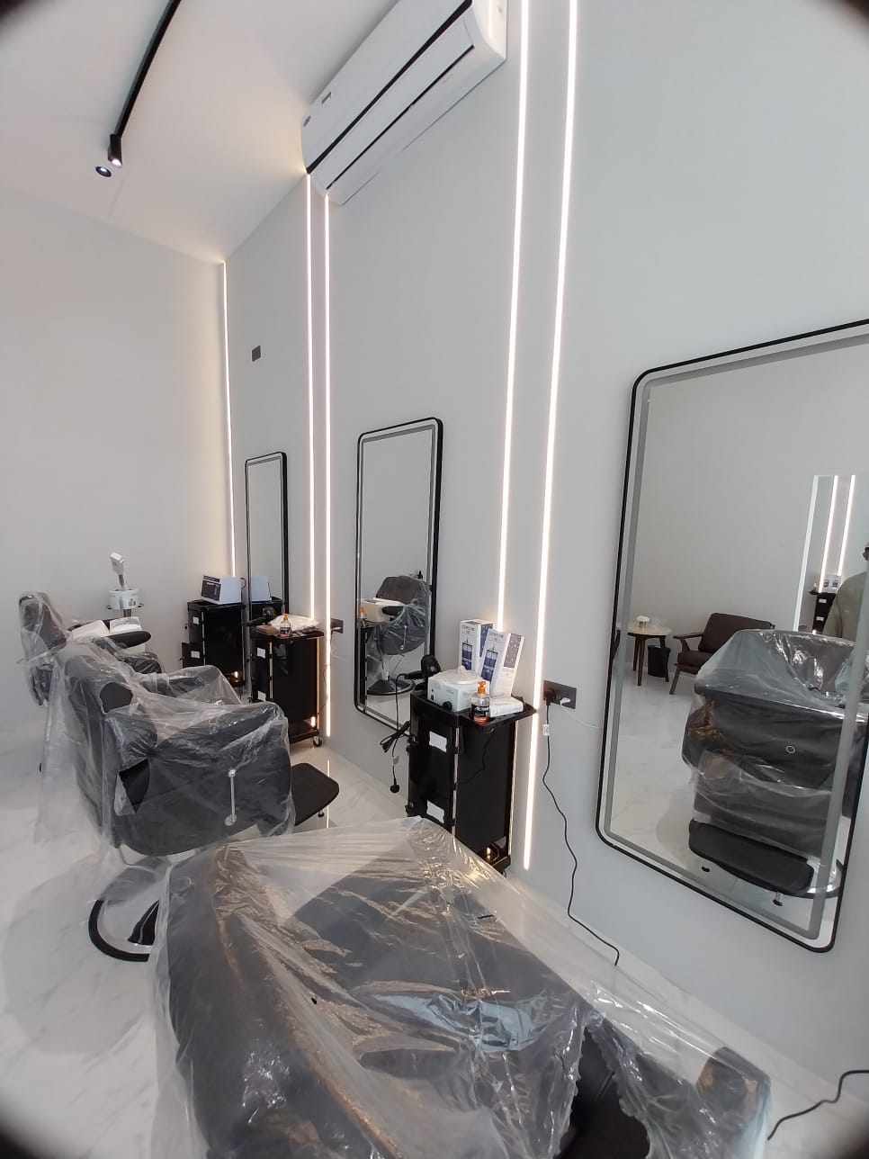 A room with a mirror and chairs AI-generated content may be incorrect.