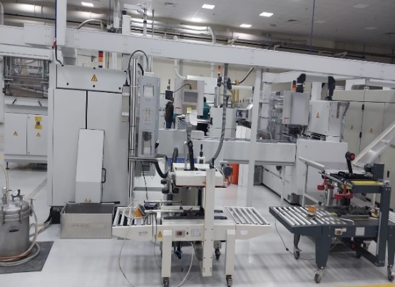A large white machine in a factory AI-generated content may be incorrect.