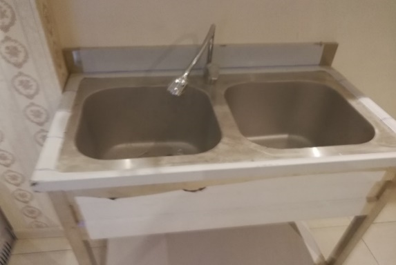 A sink with a faucet AI-generated content may be incorrect.