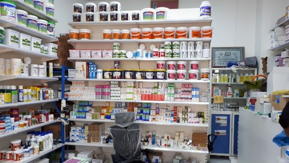 A shelf with many containers of medicine Description automatically generated with medium confidence