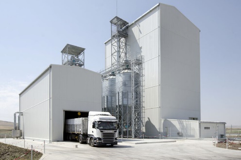 A truck parked in a warehouse Description automatically generated